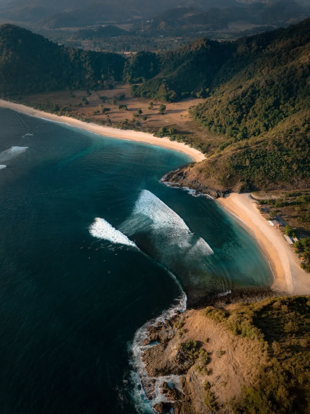Surfers in a bay on Lombok's south coast